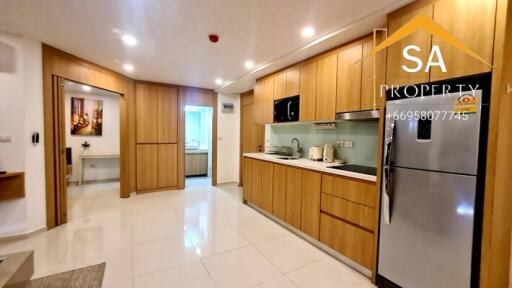 Modern kitchen with wooden cabinetry and stainless steel appliances