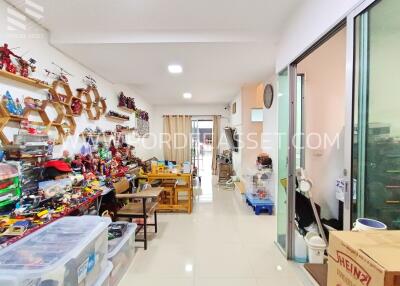 Room with shelves filled with collectibles and a table