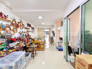 Room with shelves filled with collectibles and a table