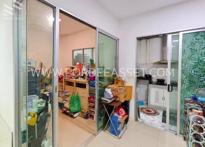 Storage room or small utility space with various items and glass partitions