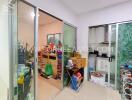 Storage room or small utility space with various items and glass partitions