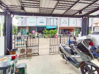 Outdoor view of residential building with garage and surrounding area