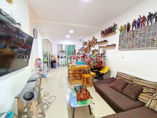 Living room with modern decor, TV, and collectibles