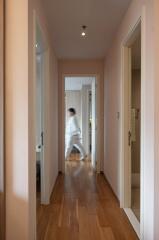 Hallway with wooden flooring and open doors