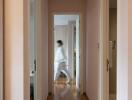 Hallway with wooden flooring and open doors