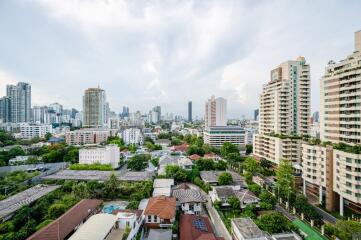 View of the city from a high-rise building, showcasing the skyline and various buildings.