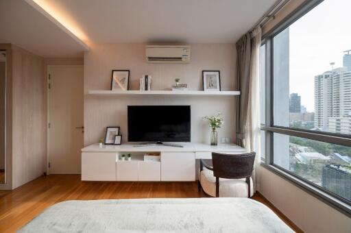 Bright living room with large window and city view