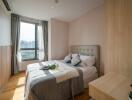 Modern bedroom with large window and city view