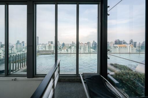 Living area with large windows overlooking a cityscape