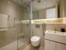 Modern bathroom with glass shower, floating toilet, and contemporary sink