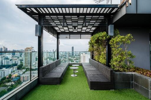 Rooftop terrace with seating area and city view