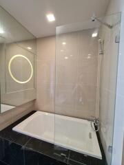 Modern bathroom with bathtub and glass shower enclosure