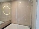 Modern bathroom with bathtub and glass shower enclosure