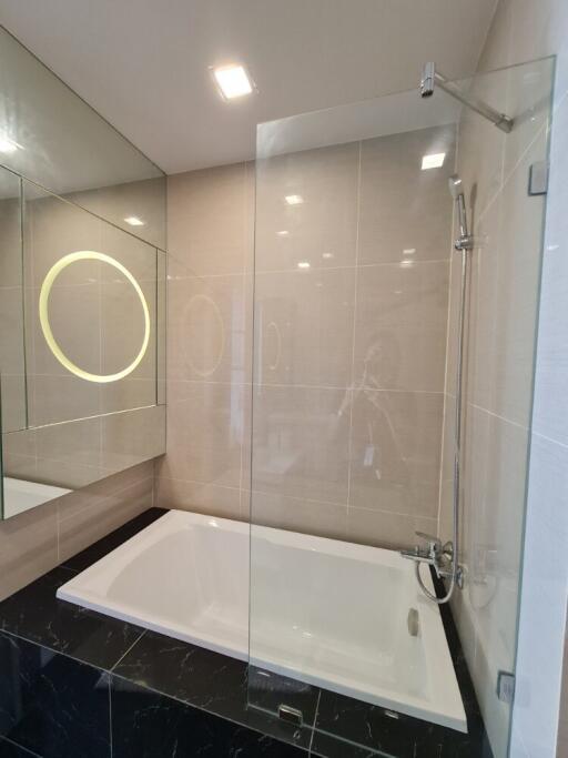 Modern bathroom with bathtub and glass shower enclosure