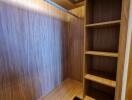 Spacious wooden built-in closet with shelves and drawers