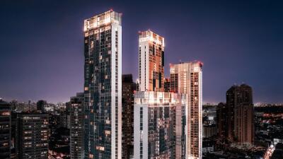 Nighttime cityscape with illuminated high-rise buildings