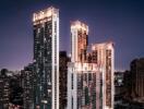 Nighttime cityscape with illuminated high-rise buildings