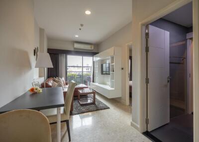 modern living area with dining table and wall-mounted TV