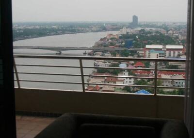 View from balcony overlooking river and city landscape