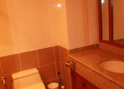 Bathroom with toilet, countertop, and sink