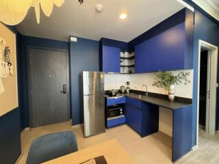 Modern kitchen with blue cabinets and stainless steel appliances