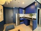 Modern kitchen area with blue cabinetry