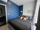 Modern bedroom with blue accent wall