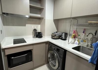 Modern kitchen with appliances and laundry area