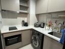 Modern kitchen with appliances and laundry area