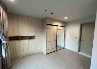 Spacious bedroom with built-in storage and mirror