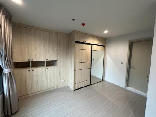 Spacious bedroom with built-in storage and mirror