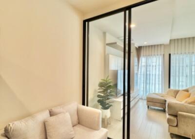 Modern living room with glass partition and light-colored sofa