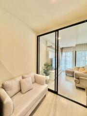 Modern living room with glass partition and light-colored sofa