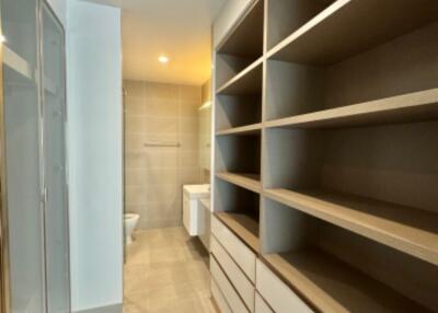 Modern bathroom with walk-in shower and ample storage space