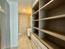 Modern bathroom with walk-in shower and ample storage space