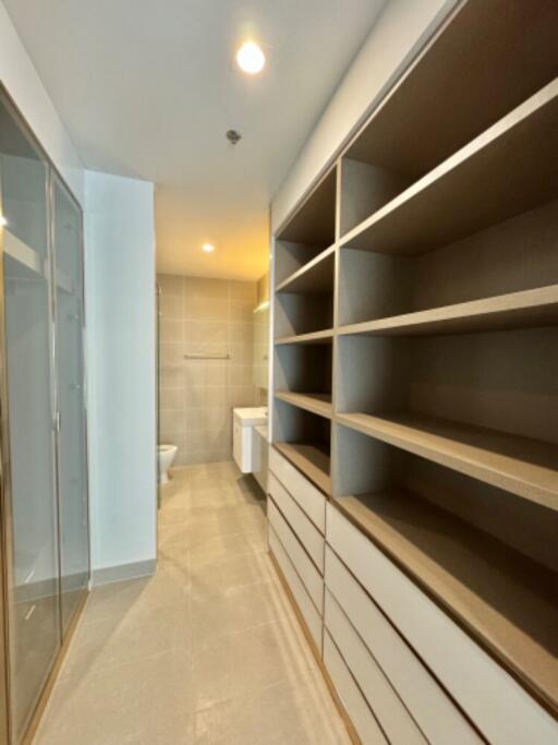 Modern bathroom with walk-in shower and ample storage space