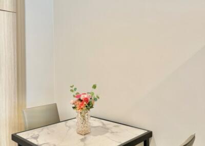 Small dining area with a marble-top table and two chairs