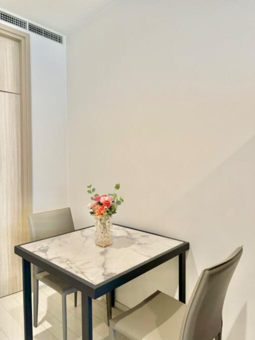 Small dining area with a marble-top table and two chairs