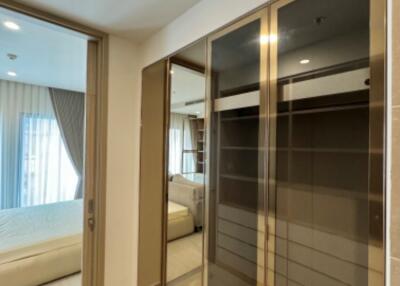 Spacious bedroom with large mirrored wardrobe and ample natural light