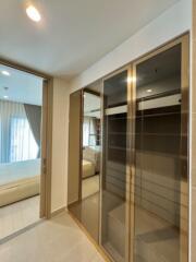 Spacious bedroom with large mirrored wardrobe and ample natural light