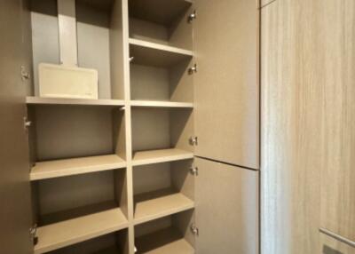 Empty closet with shelves and open door