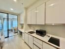 Modern kitchen area with appliances and view towards living space