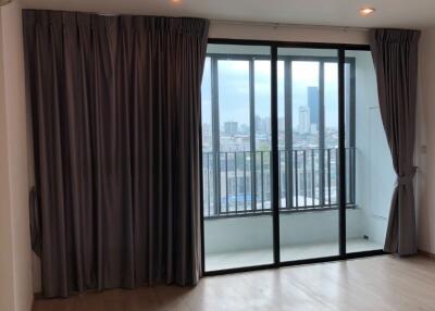 Spacious living room with large windows and balcony access