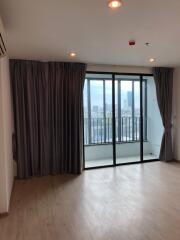 Spacious living room with large windows and balcony access