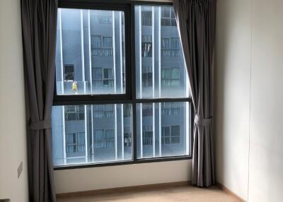 A small bedroom with large windows