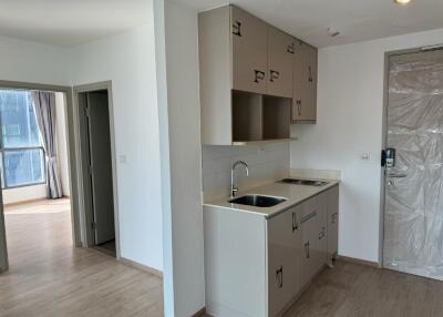 Small kitchen area with sink and cabinets