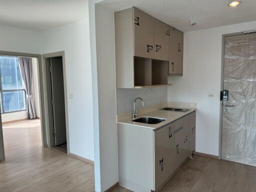 Small kitchen area with sink and cabinets