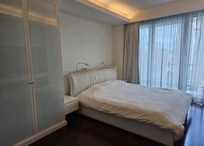 Spacious bedroom with a large bed and wardrobe