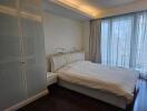 Spacious bedroom with a large bed and wardrobe