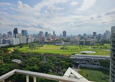 View from balcony overlooking cityscape and green park